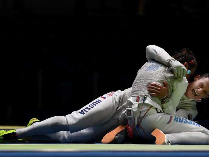 Russian fencers celebrate after defeating the US in the team semifinal.