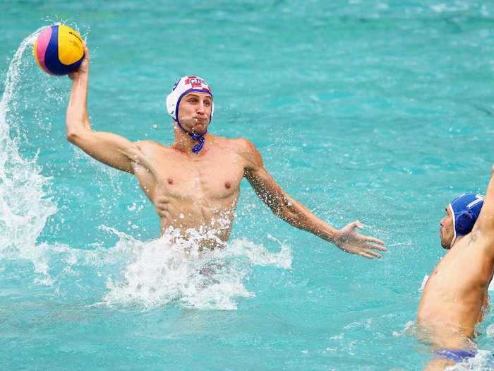 A Croatian water-polo player rises out of the water for a shot.