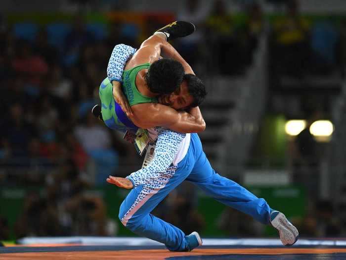 A wrestler from Uzbekistan celebrating (not wrestling!) with his coach after a bronze medal.