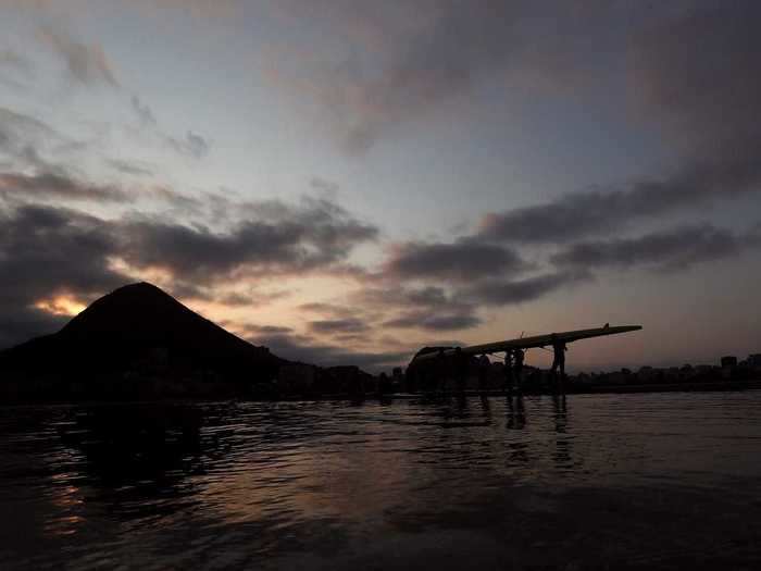 Rowers take the water early in the morning.