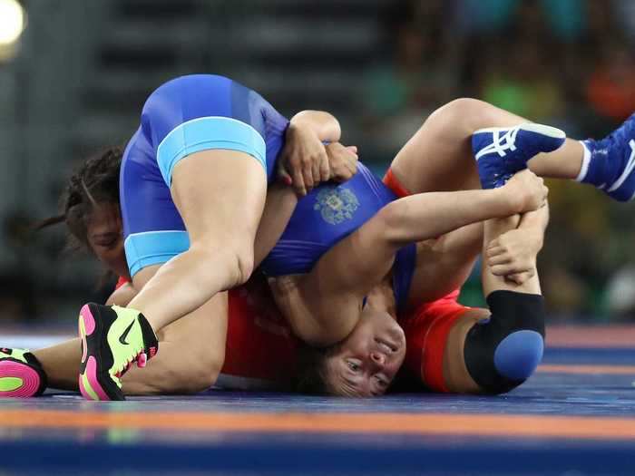 Russian and Mongolian wrestlers, wrestling.