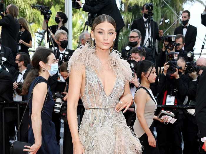 Lorena Rae dazzled in a tan minidress with beads, feathers, and a skirt train.