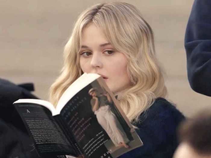 Audrey Hope (Emily Alyn Lind) reads "Ornament and Silence: Essays on Women