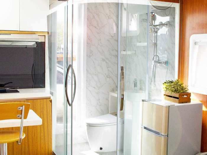 Moving towards the bathroom, the tiny Cube One comes with a shower, towel rack, and sink, all in one enclosed space.