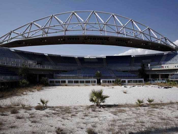 The beach volleyball court is being consumed by weeds.