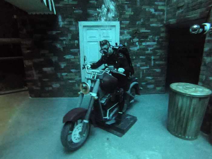 The sunken city is set up with various props that include a motorcycle and a shopping cart.