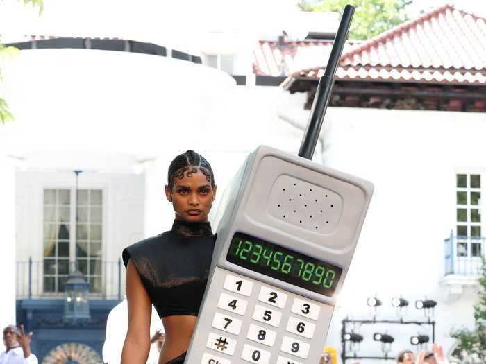 One model walked the runway with an oversized cell phone - a nod to technology pioneer Henry T. Sampson.