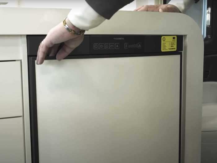 … a sink with a cutting board cover, and a refrigerator-freezer.