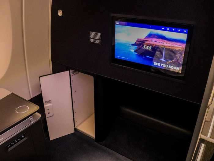 One perk of sitting in the first row of either of the business class cabins is a small closet that the other seats do not have. It can be used to store a bag or purse.