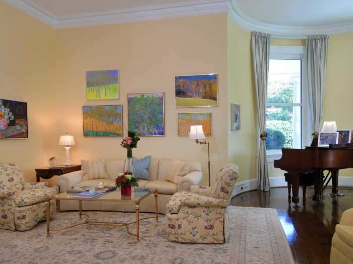 The living room was painted a brighter yellow, and the furniture and artwork were swapped out to feel more homey.