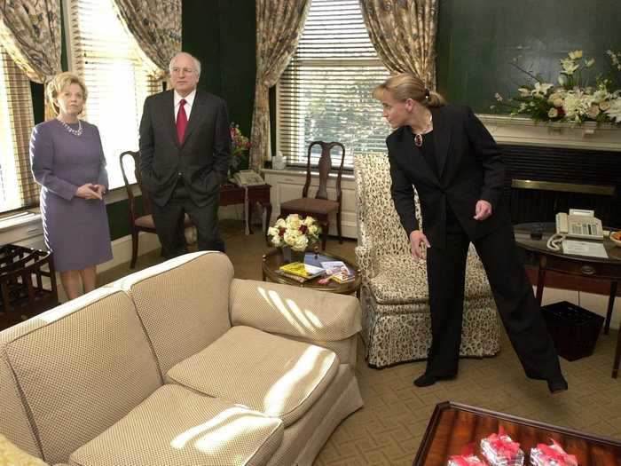 Upstairs in the private quarters, the neutral furniture was offset with dark green walls and floral curtains.