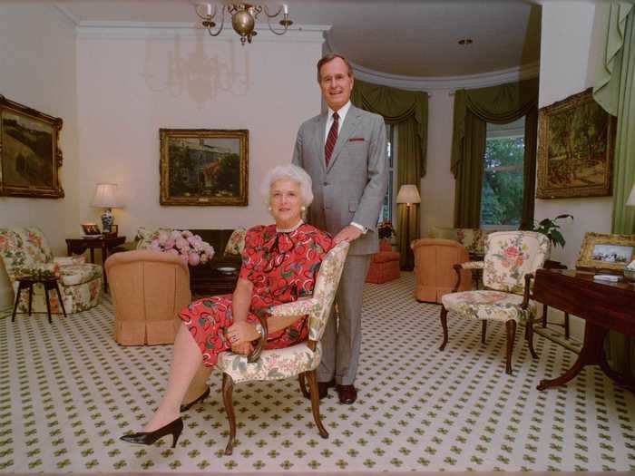 In the living room, the Bushes added a patterned rug, floral chairs, and green drapes.