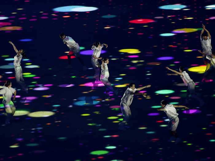 NOW: Tokyo 2020 - Performers dance during the opening ceremony of the Tokyo Olympic Games.