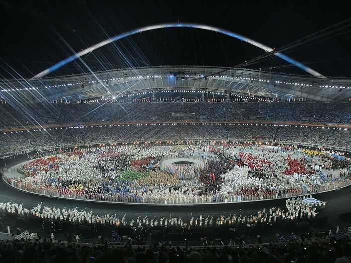 THEN: Athens 2004 - Teams enter the stadium for the parade of nations in the Athens 2004 Summer Olympic Games.