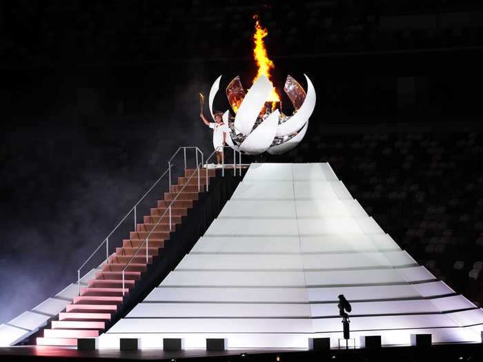 NOW: Tokyo 2020 - Naomi Osaka lights the Olympic cauldron in an empty Olympic Stadium in Tokyo, Japan.