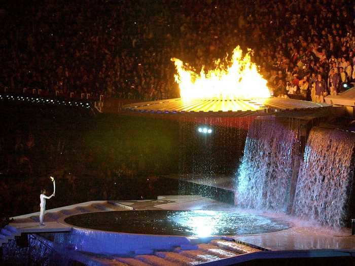 THEN: Sydney 2000 - Fans look on as Cathy Freeman lights the Olympic cauldron at the 2000 Summer Olympics in Sydney, Australia.