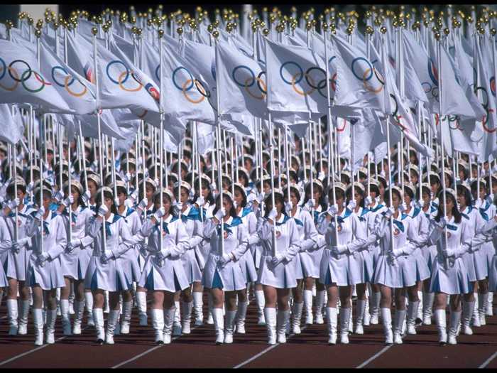 THEN: Seoul 1988 - Olympic flag bearers march in the Seoul 1988 Olympics opening ceremony.