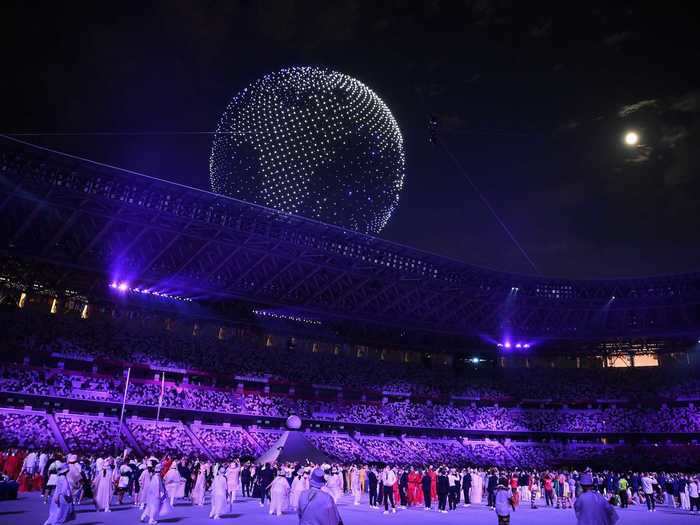 NOW: Tokyo 2020 - A drone display is seen over the top of the stadium during the Tokyo Olympics opening ceremony.