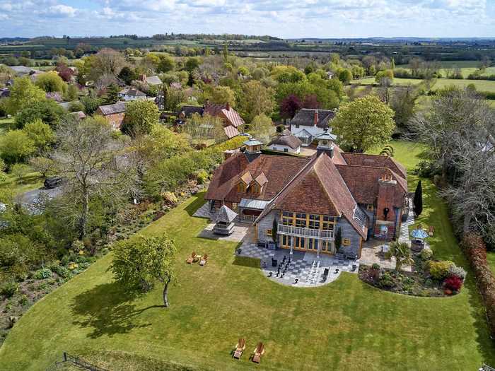 The property spans 12,000 square feet and includes two semi-detached thatched cottages, each with two additional bedrooms.