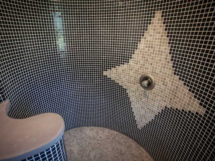 The bathroom is located in the middle of the curved floor plan, and its shower tops off the center of the spiral.