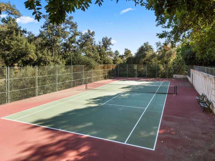 At the far end of the property sits a sunken championship tennis court.