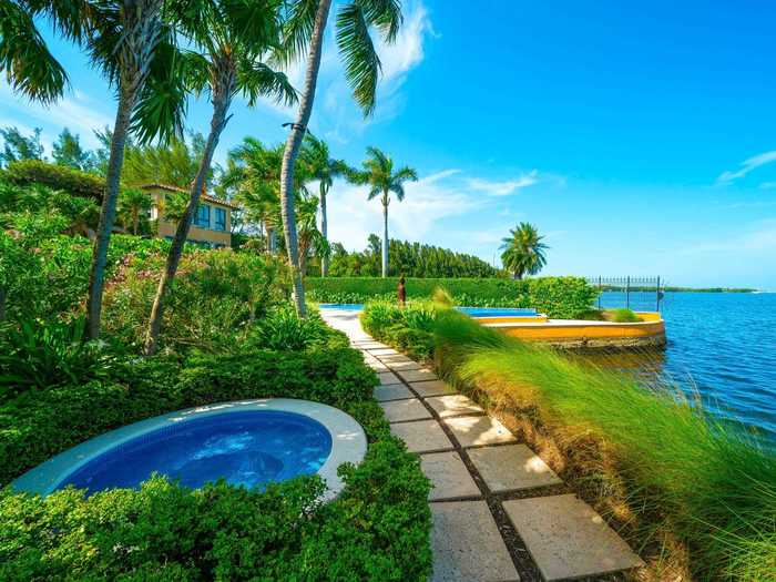 Nearby, a Jacuzzi overlooks the water.