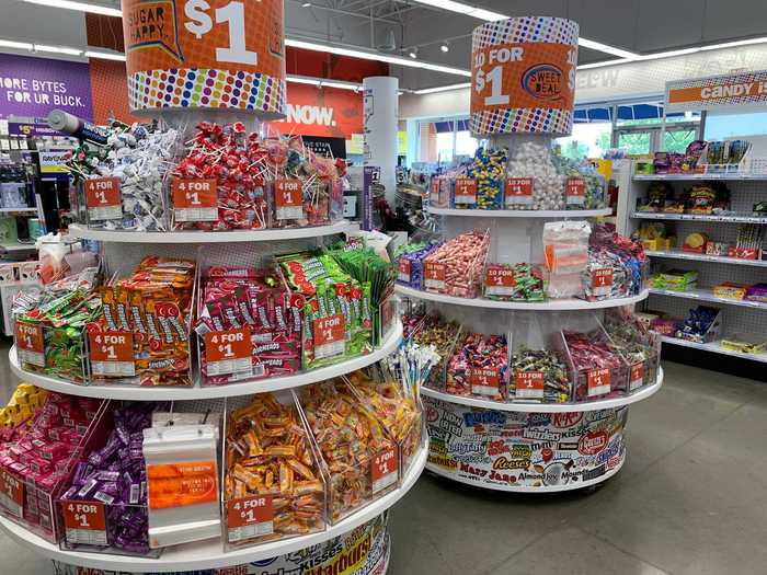 To reach the checkout area and leave, customers have to walk through a large display of candy and snacks, a kind of enhanced version of checkout lane candy bars in a grocery store designed to be noticed by customers and purchased at the last minute.