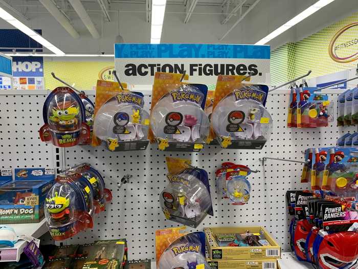 Action figures, collectibles, and small toys are all grouped together in a shared display.