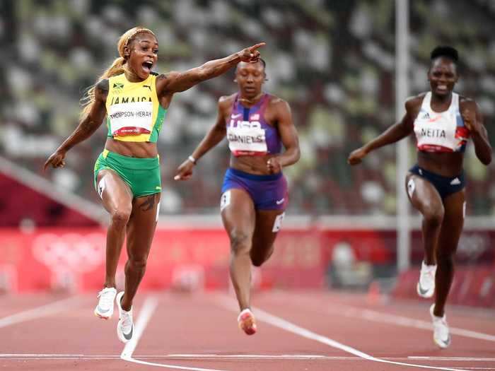 7/31: Elaine Thompson-Herah of Team Jamaica crosses the finish line to win the gold medal in the Women