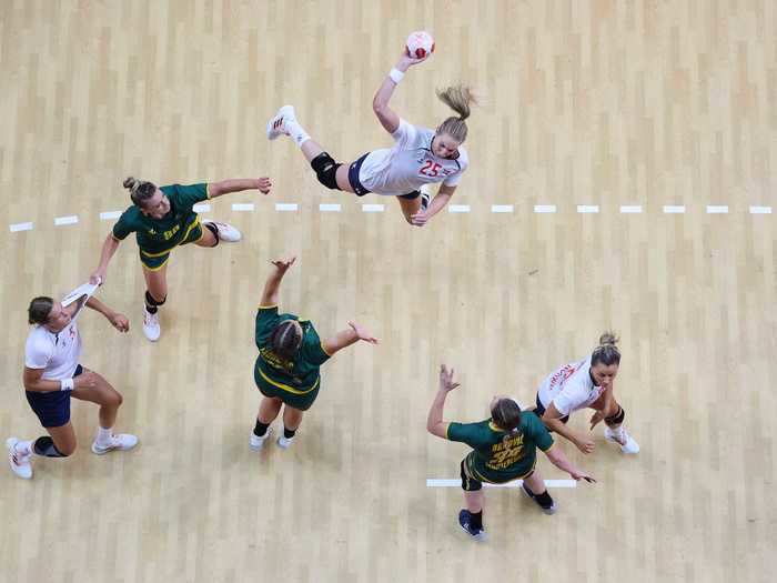 7/29: Kristine Breistoel of Team Norway shoots at goal over Durdina Jaukovic and Tatjana Brnovic of Team Montenegro during a women