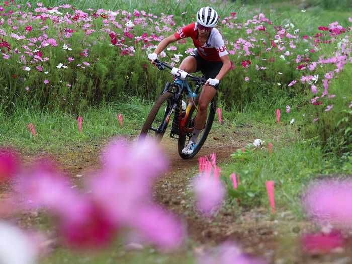 7/27: Jolanda Neff of Team Switzerland rides through flowery landscape during the Women