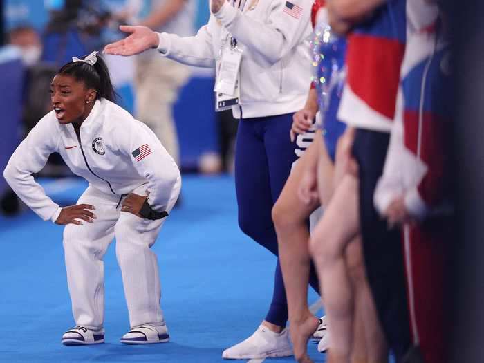 7/27: American Simone Biles cheers for her teammates during the Women