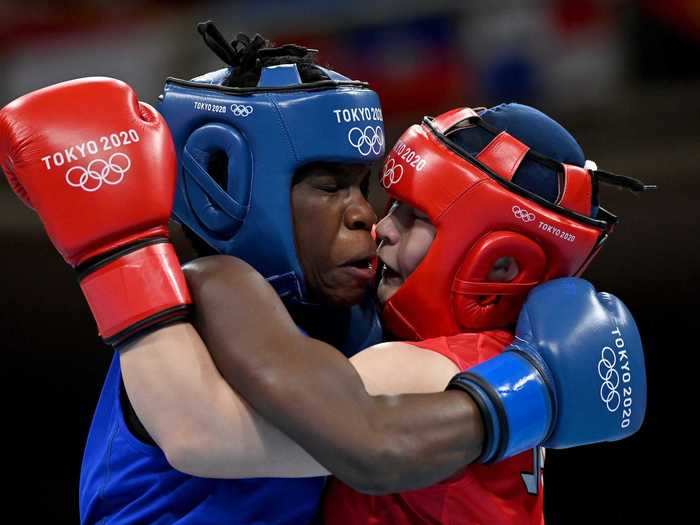 7/25: Tsukimi Namiki of Japan exchanges punches with Catherine Nanziri of Uganda during the Women