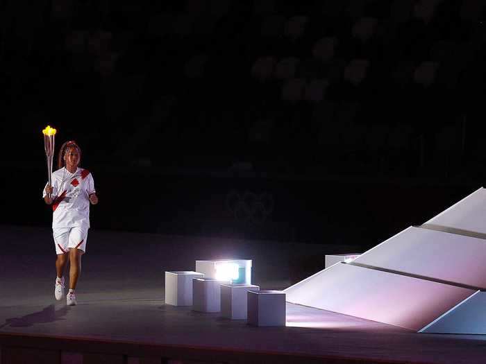 7/23: Naomi Osaka of Team Japan lights the Olympic cauldron in Tokyo.