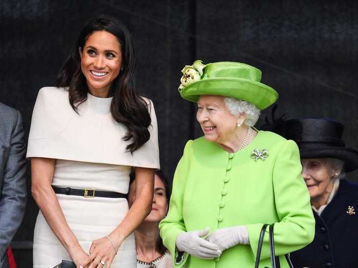 On a visit to Cheshire, UK, with the Queen, Markle wore a beige dress with cape-like sleeves.