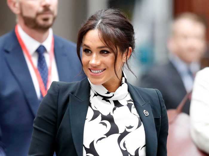 Markle wore a retro-inspired black-and-white mini dress to speak on a panel for International Women