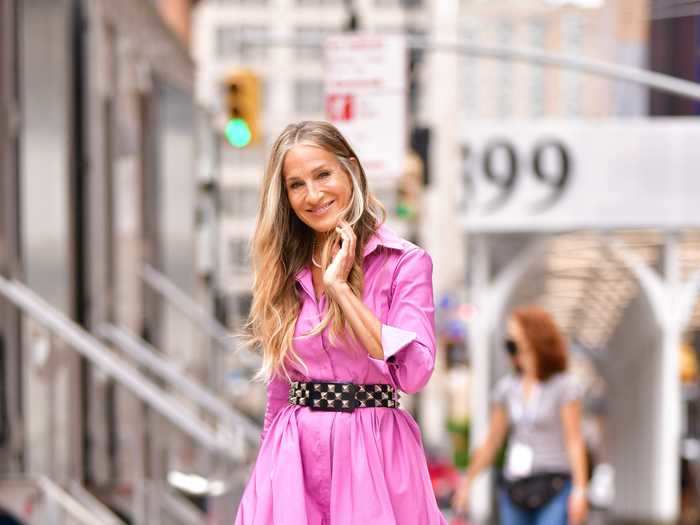 Parker was photographed the next day wearing a fuchsia Carolina Herrera dress and a statement studded belt from the first "Sex and the City" movie.