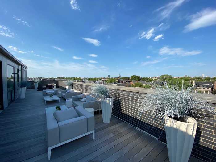 The penthouse has a private patio space with sweeping views of Lincoln Park.