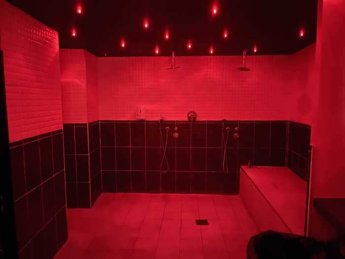 A group shower with red mood lighting also welcomed horny guests.