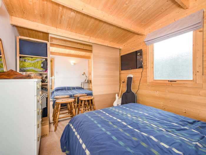 Upstairs, the wooden cozy vibe continues into one bedroom.