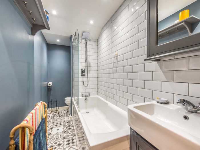 The first-floor bathroom is just over four feet wide, but it fits a full-sized bath and shower, according to Jam Press.