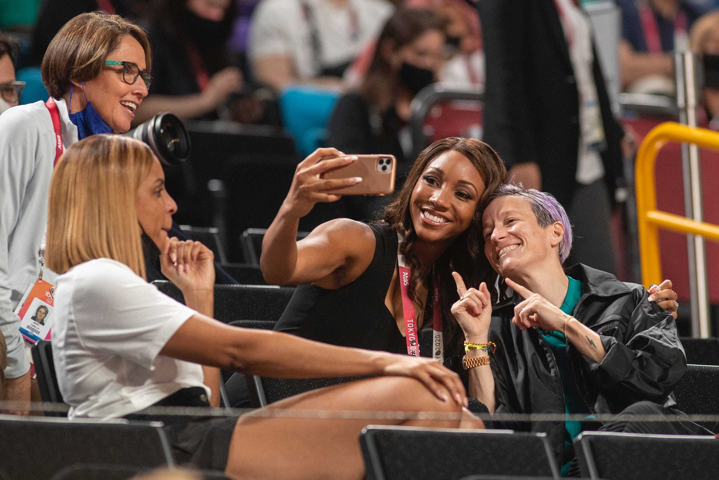 Mary Carillo, LaChina Robinson, Maria Taylor, and Megan Rapinoe sit in the stands.