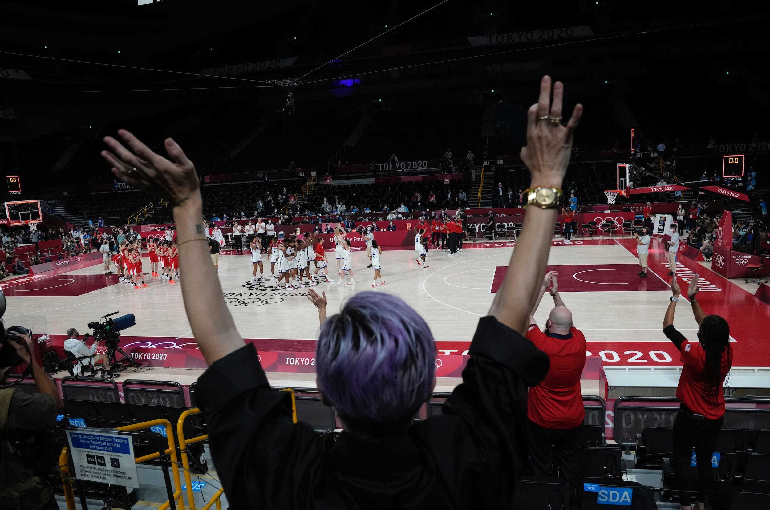 Megan Rapinoe cheers on USA Basketball from the stands.