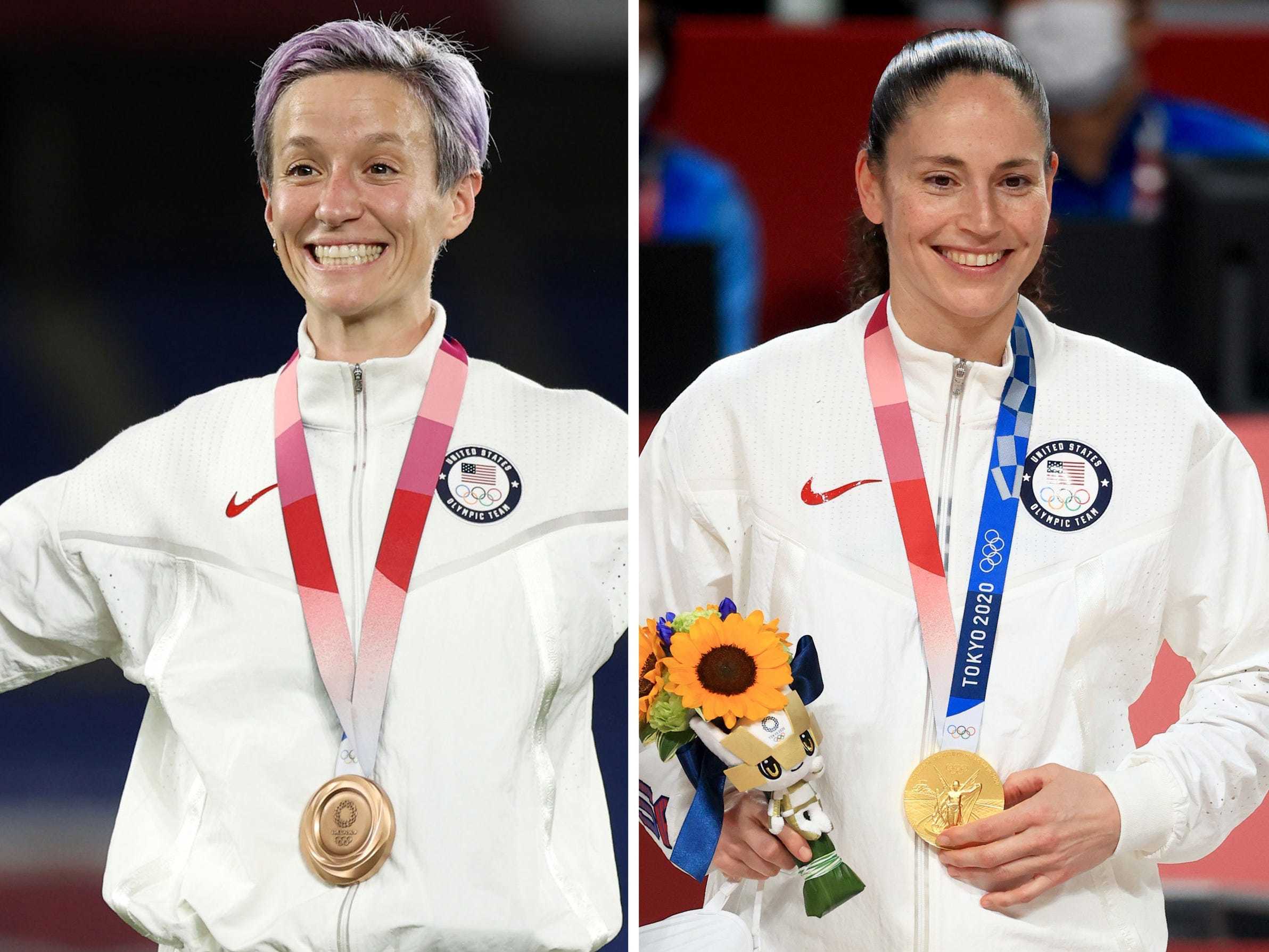 Megan Rapinoe poses with her bronze medal from Tokyo, and Sue Bird poses with her gold medal from Tokyo.