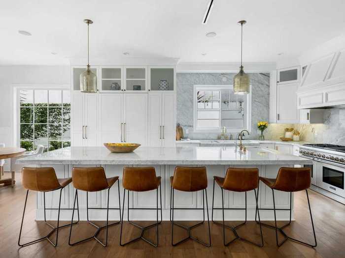 Down the hall from the formal living room is the kitchen, which features marble countertops and stainless steel appliances.