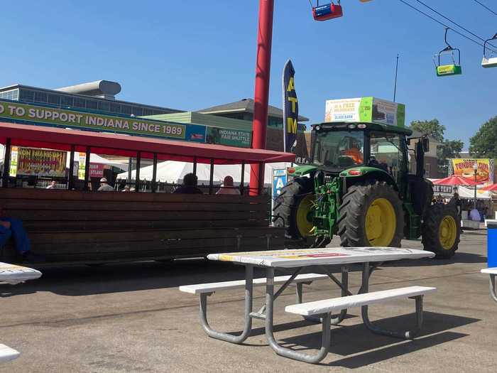 Basically, these shuttles were tractors tasked with pulling around what looked like rolling benches. If you were tired, you could hop aboard for a ride. By the end of fair - when we felt too tired to do much more walking - these shuttles became a real lifesaver.