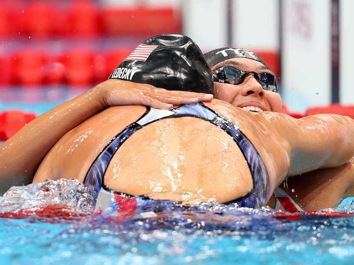 Ledecky hugs fellow Team USA swimmer Erica Sullivan after they took gold and silver, respectively, in the inaugural women