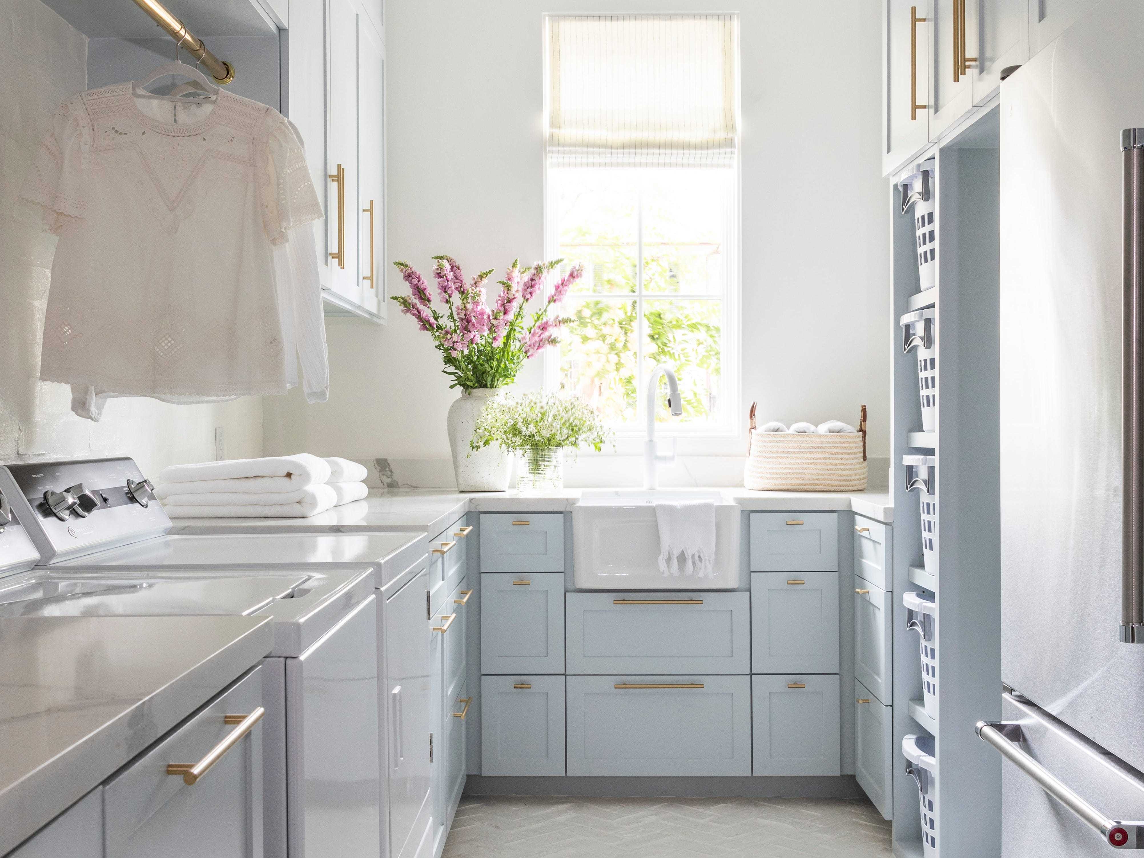 A light blue laundry room with lots of lighting.