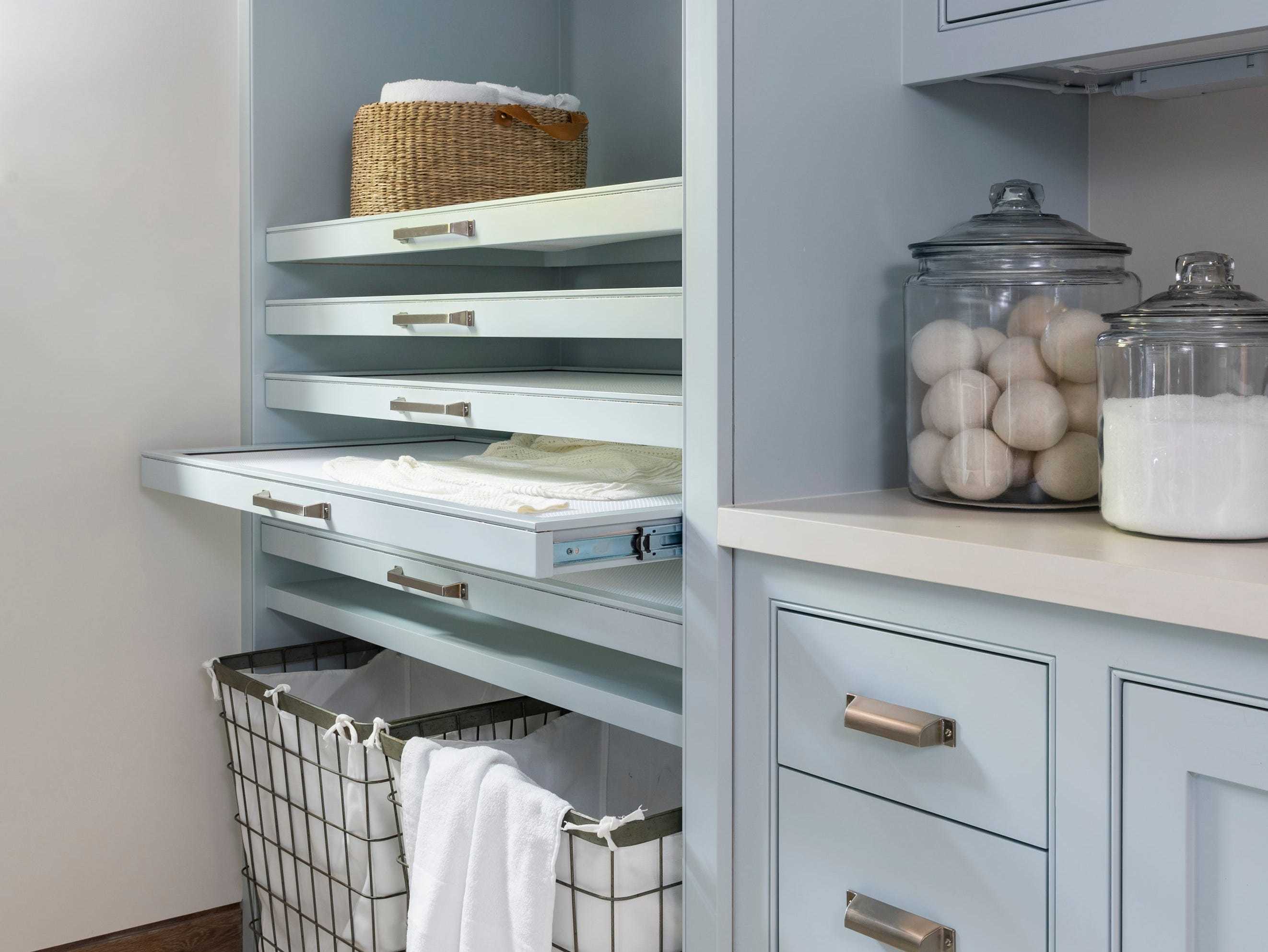 Light blue cabinets and wire baskets.