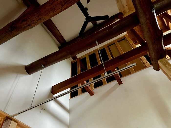 They also removed the kitchen ceiling to bring in more light, expose the wood beams, and create a small loft area above the kitchen.